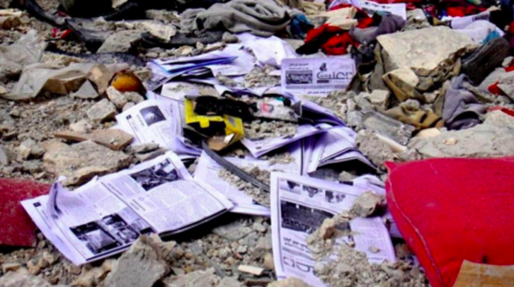 Copies of Enab Baladi on the floor after regime soldiers destroyed their office. Image source: Raw in War.